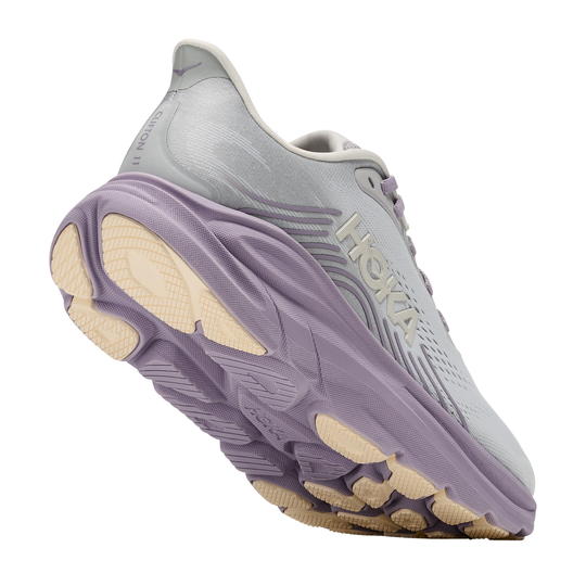Gray running shoe with purple sole on a white background