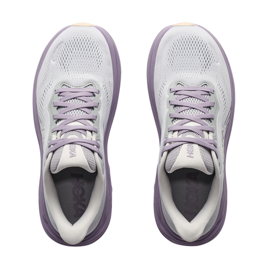 Pair of white and purple running shoes on a white background
