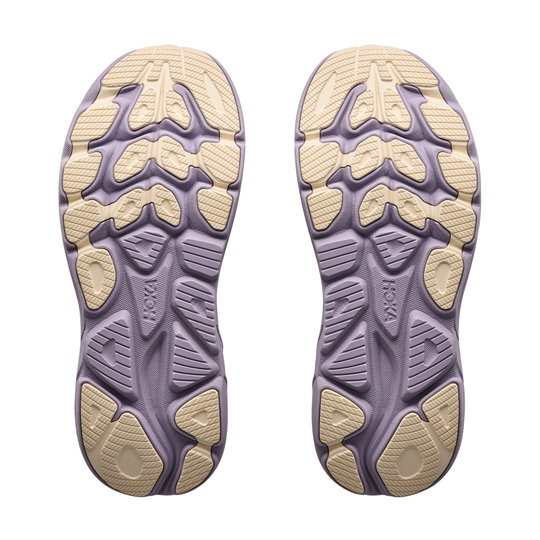 Close-up of a pair of purple and beige shoe soles on a white background