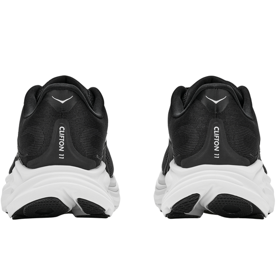 Black running shoes with white soles on a white background