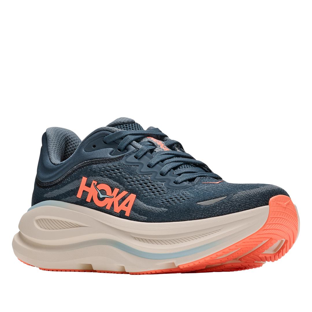 Blue running shoe with orange sole on a white background