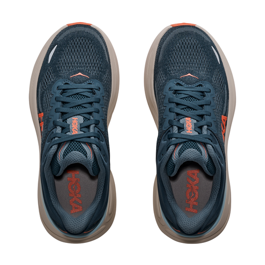 Pair of blue running shoes with orange accents on a white background