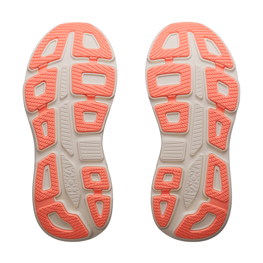 Close-up of the sole of a running shoe with orange and beige pattern on a white background