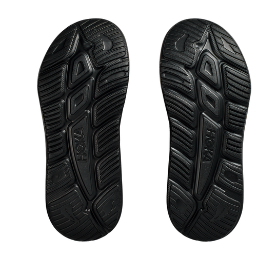 Black sole of a shoe with 'Hoka' branding on a white background