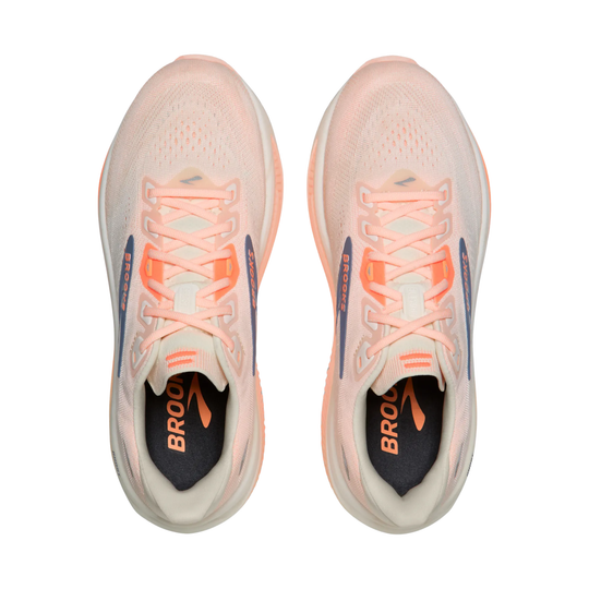 Pair of running shoes with pink and orange accents on a white background