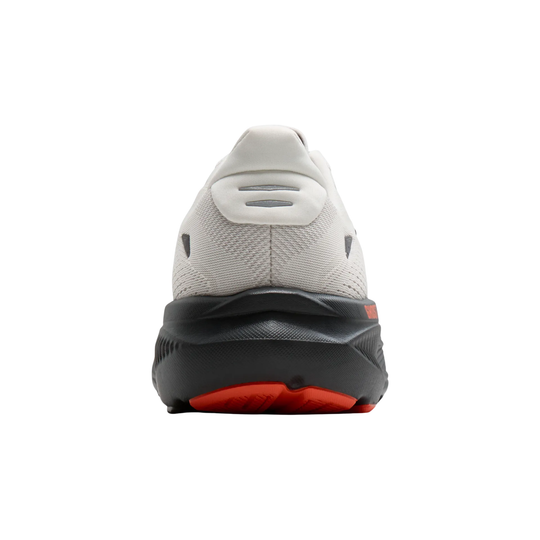Back view of a white athletic shoe with red sole on a white background