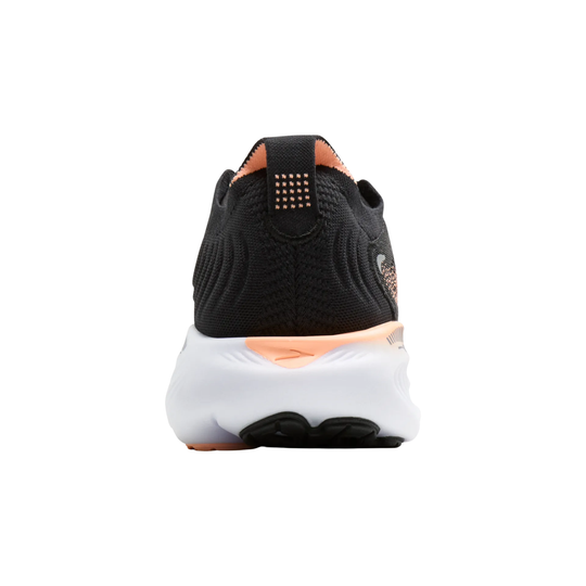 Black and white sneaker with orange accents on a white background