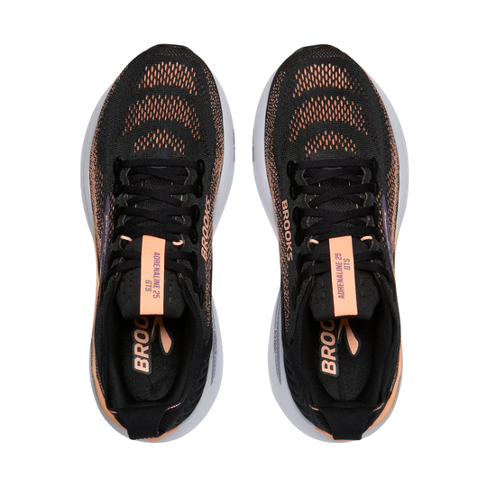 Black running shoes with orange accents on a white background