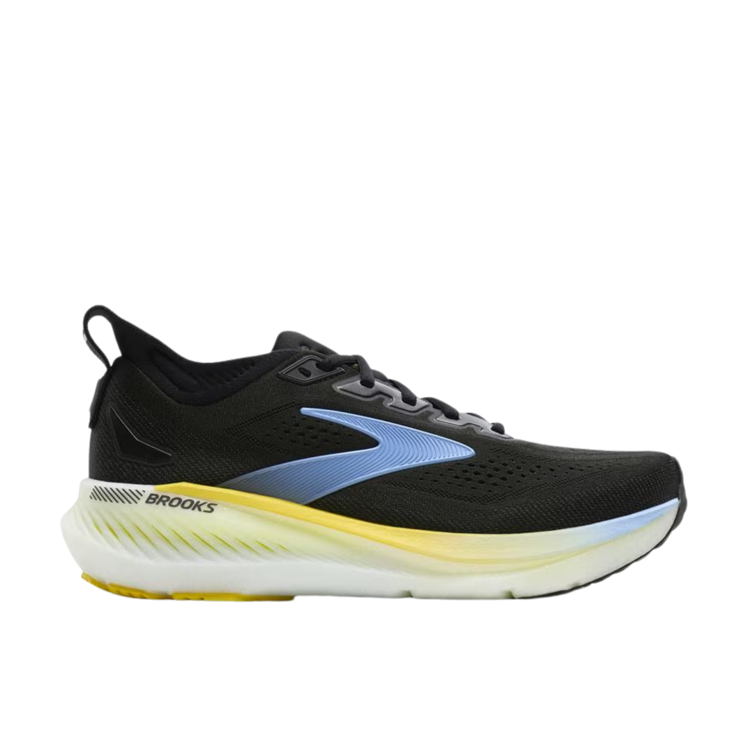 Black running shoe with yellow sole on a white background