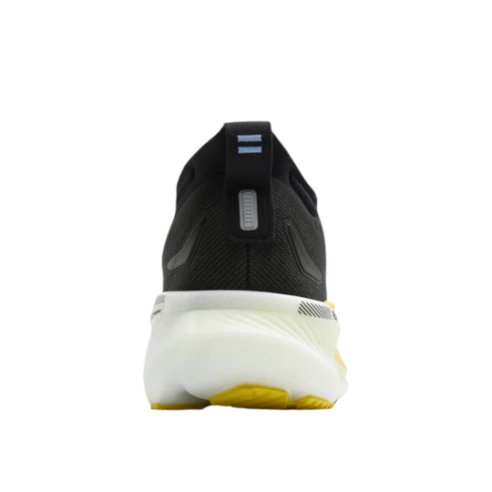 Black and white athletic shoe with yellow sole on a white background