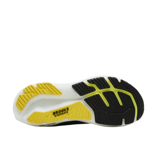 Sole of a running shoe with yellow and black tread pattern on a white background
