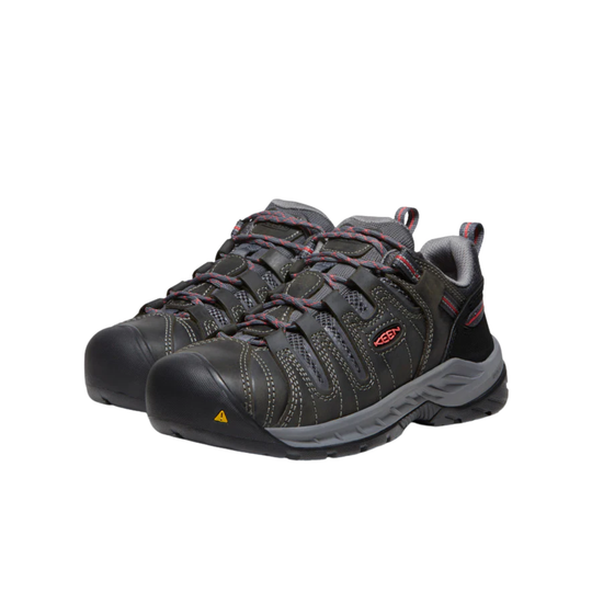 Pair of black and gray shoes with red accents on a white background