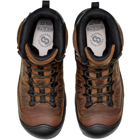 Pair of brown leather boots with black soles on a white background