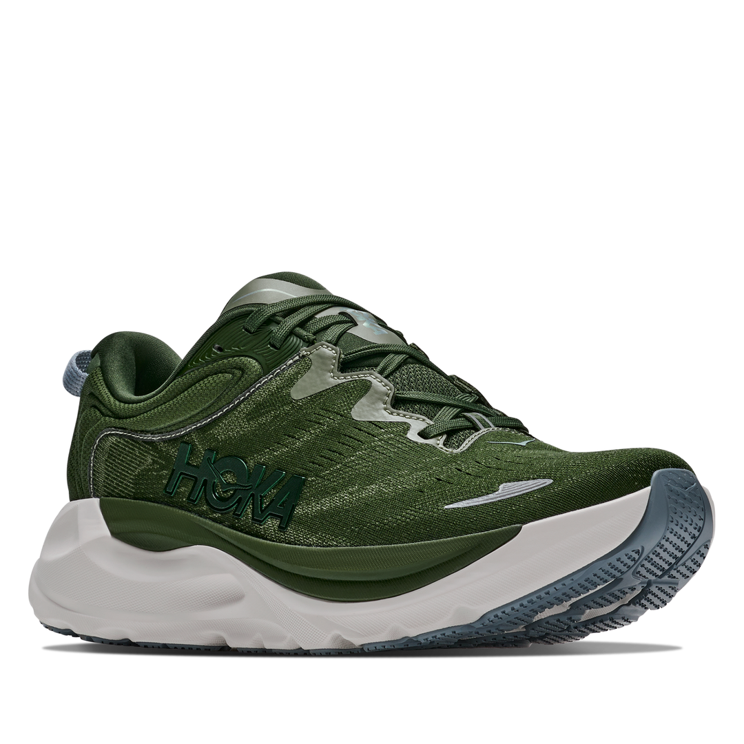 Green running shoe with white sole on a white background