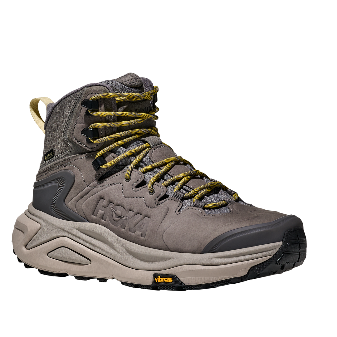 Gray hiking boot with yellow laces on a white background