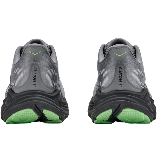 Gray running shoes with green soles on a white background