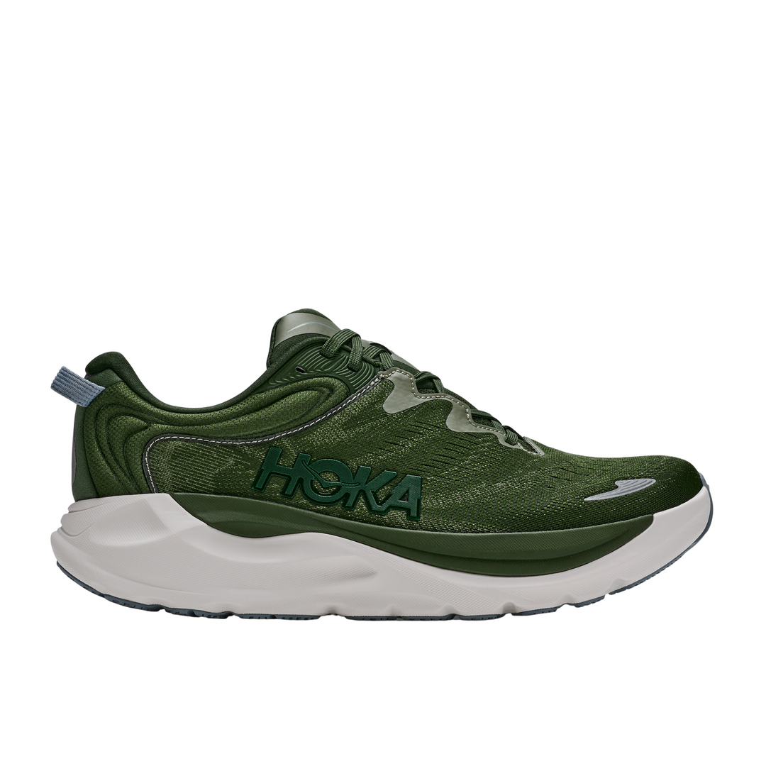 Green running shoe with white sole on a white background