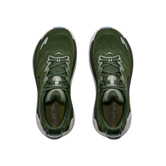 Green athletic shoes with white accents on a white background