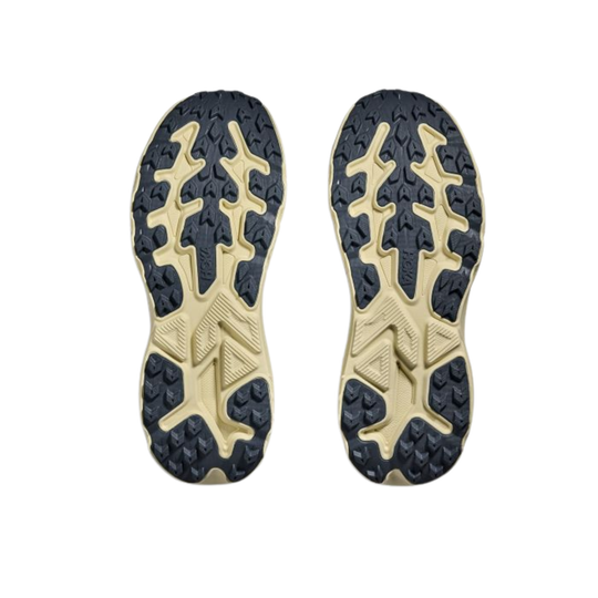 Close-up of a pair of shoe soles with tread pattern on a white background