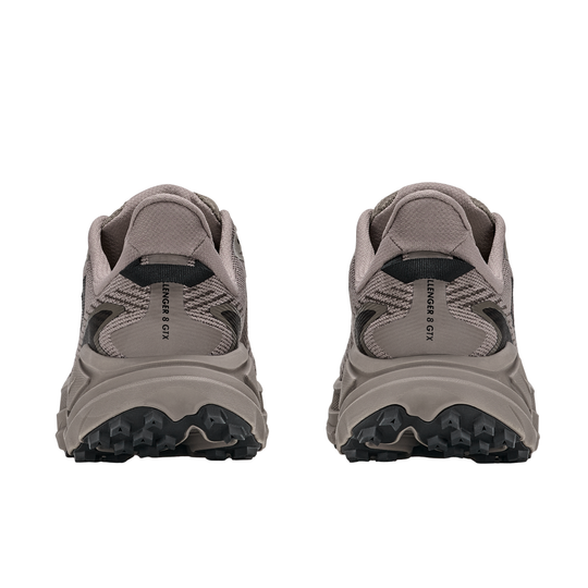 Pair of gray running shoes with black soles on a white background