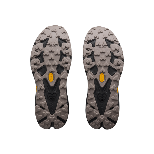 Gray and black sole of a shoe with a brand logo on a white background