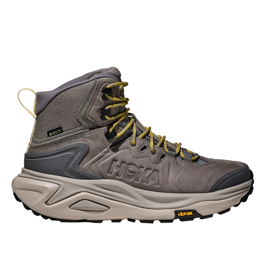 Gray hiking boot with yellow laces on a white background