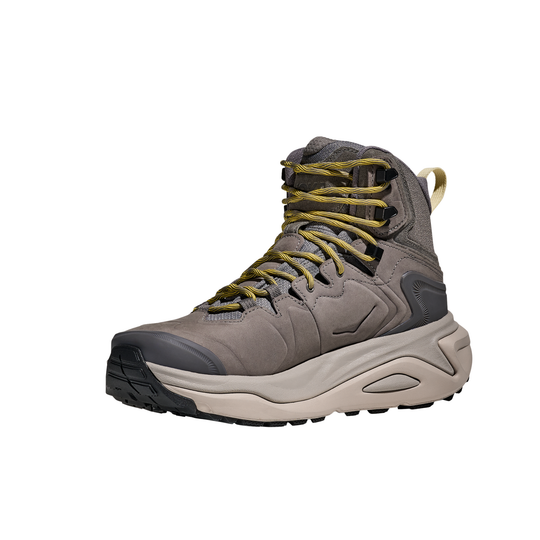 Gray hiking boot with yellow laces on a white background