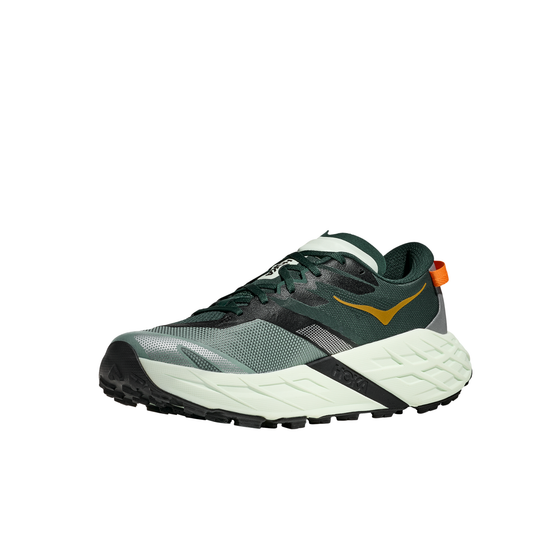Green running shoe with black sole on a white background