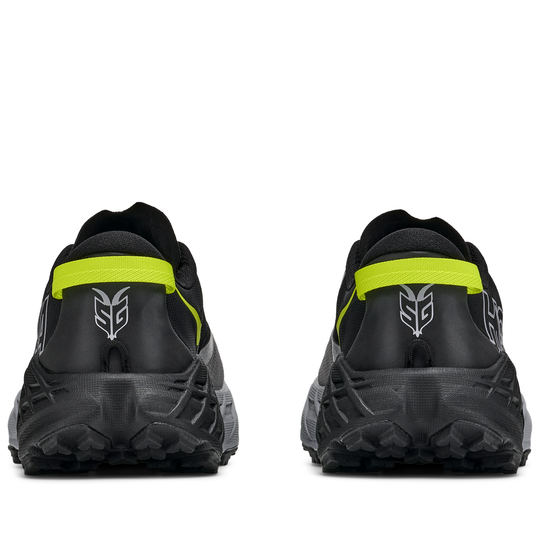 Black athletic shoes with yellow accents on a white background