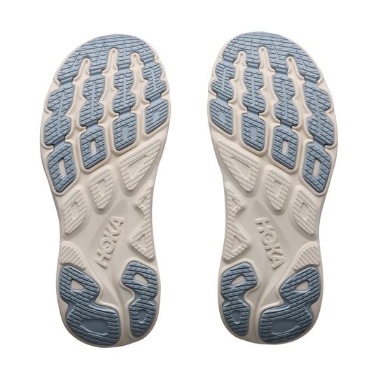 Close-up of Hoka running shoes with blue and beige sole design on a white background