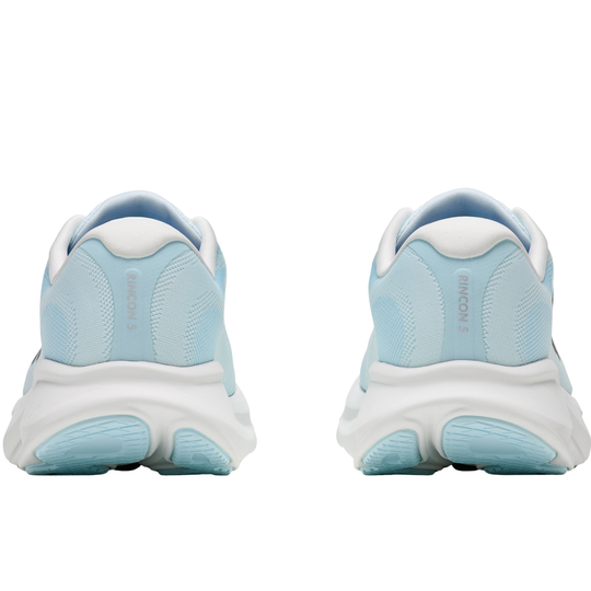 Light blue running shoes with white soles on a white background