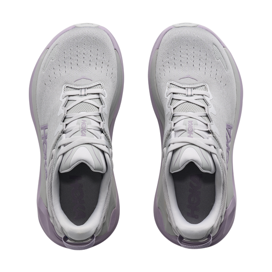 Pair of light gray sneakers with purple accents on a white background