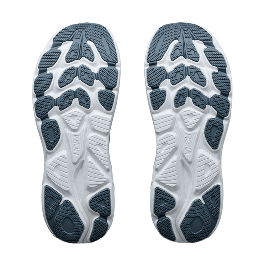 Close-up of the sole of a shoe with a visible brand logo on a white background
