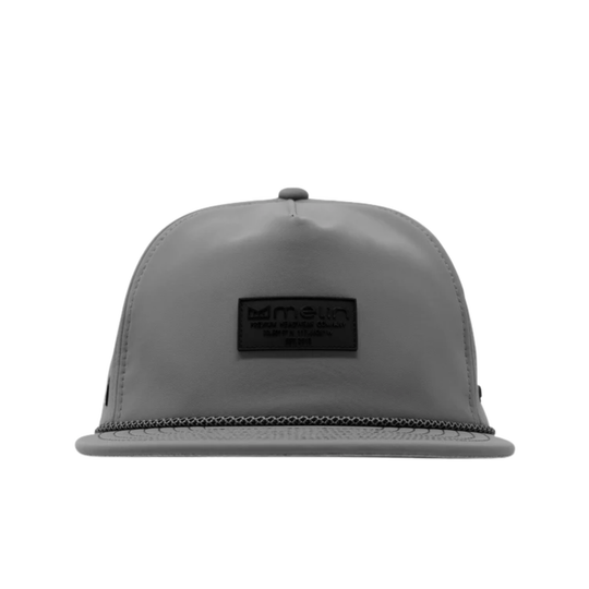 A gray snapback cap with a black rectangular logo patch on the front, photographed against a solid white background.
