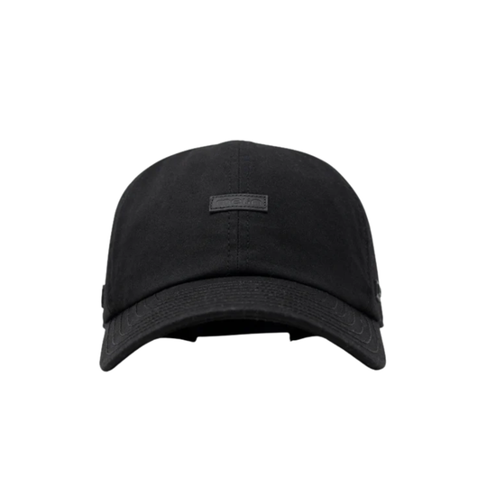 A black baseball cap with a curved brim and a small rectangular black logo patch on the front, shown against a plain white background.