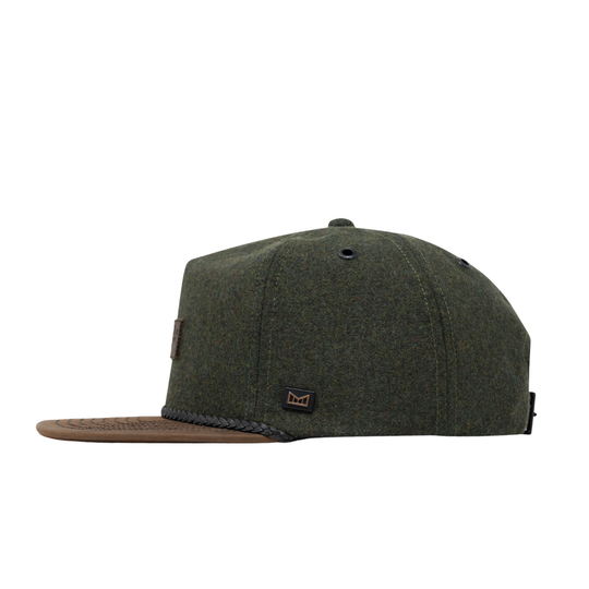 An olive green woven baseball cap with a brown flat brim, featuring a braided trim along the edge of the brim and a small embroidered logo patch on the front.