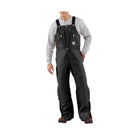 Person wearing black bib overalls on a white background