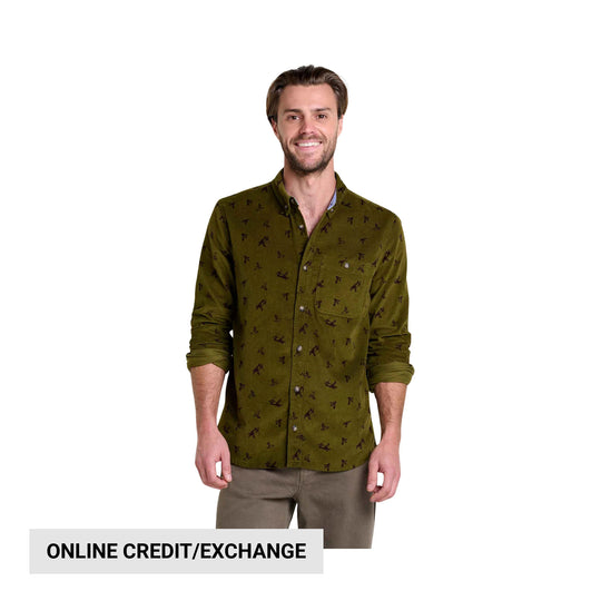 Man wearing an olive green patterned button-up shirt with rolled sleeves and taupe pants