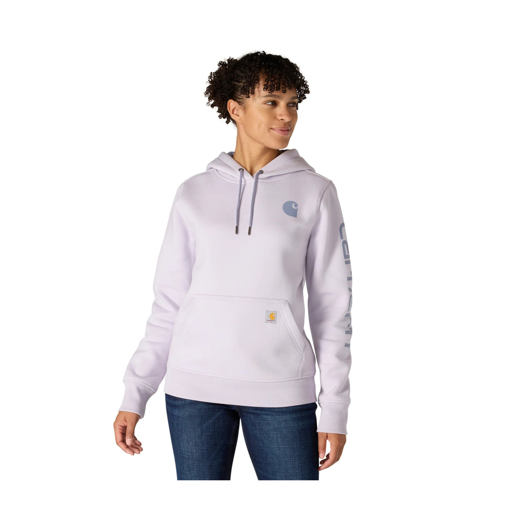 Person wearing a light purple hoodie with a brand logo on a white background