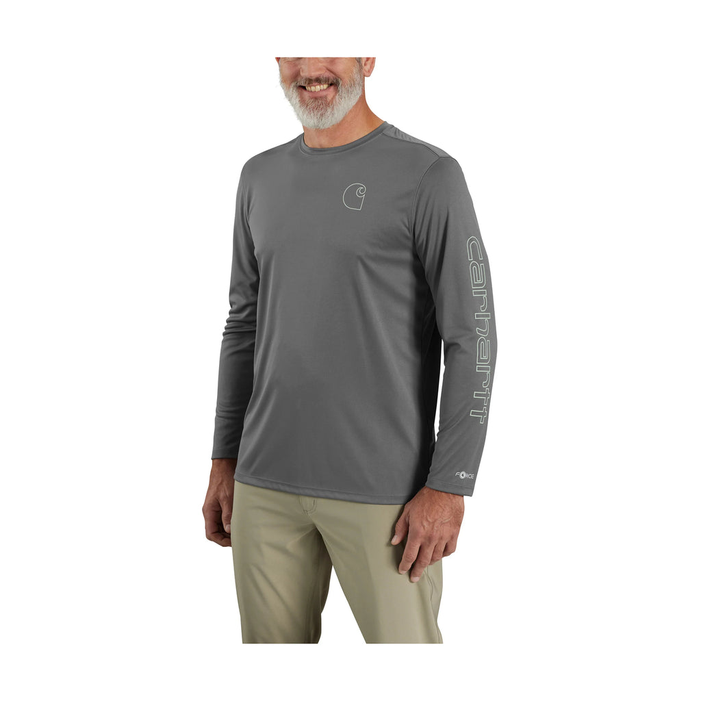 Person wearing a gray long-sleeve shirt and beige pants on a white background