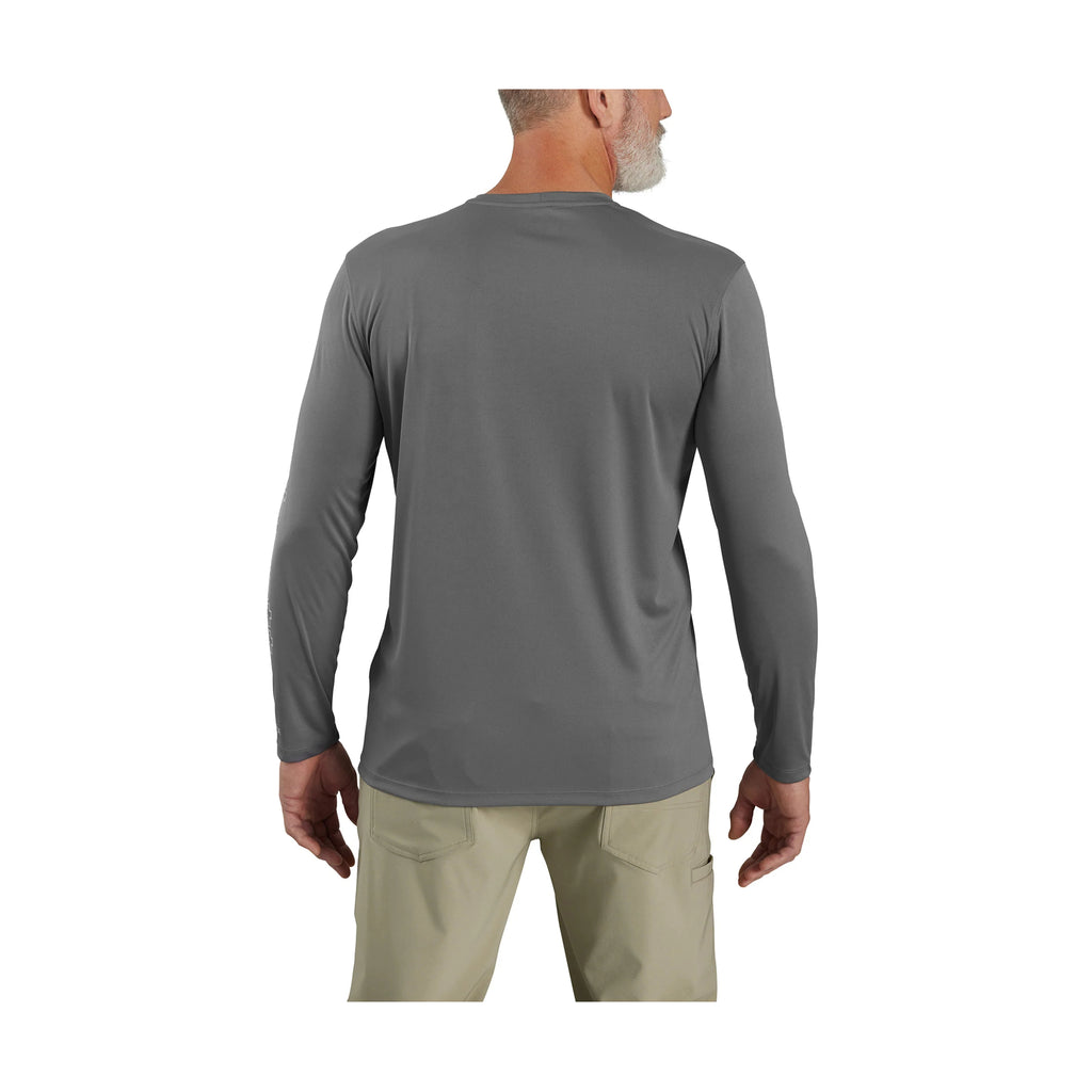Person wearing a gray long-sleeve shirt and beige pants on a white background