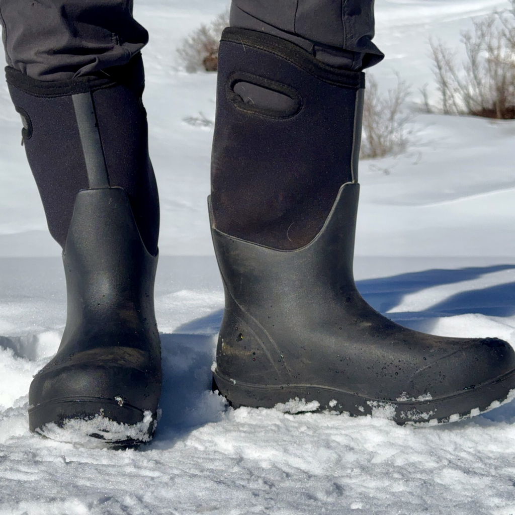 Black rubber boots on a snowy ground