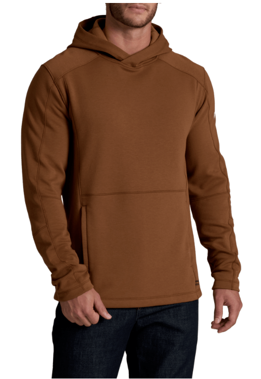 A man wearing a brown hooded sweatshirt with a kangaroo pocket, paired with dark blue jeans, shown against a plain white background.