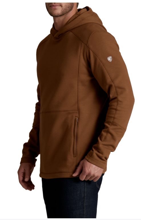 A man wearing a brown hooded sweatshirt with a vertical zippered pocket on the front and a small white embroidered logo on the upper left sleeve, shown against a plain white background.