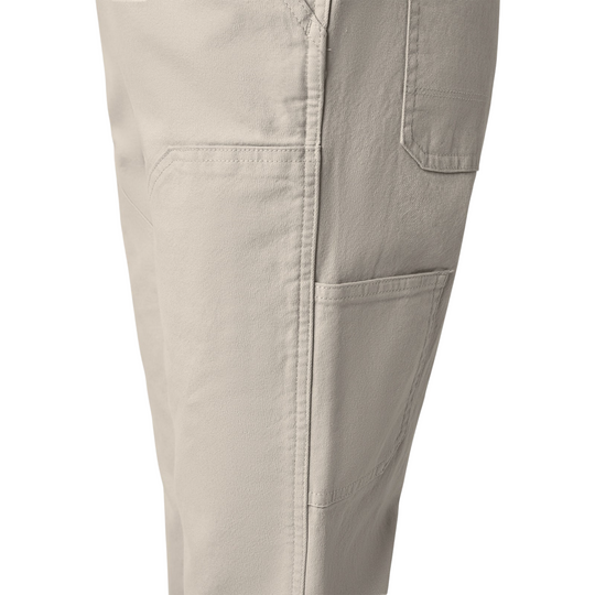 Dickies Women's Double Front Bib Overalls - Rinsed Stone on a female model on a white background. Close up of leg pockets.