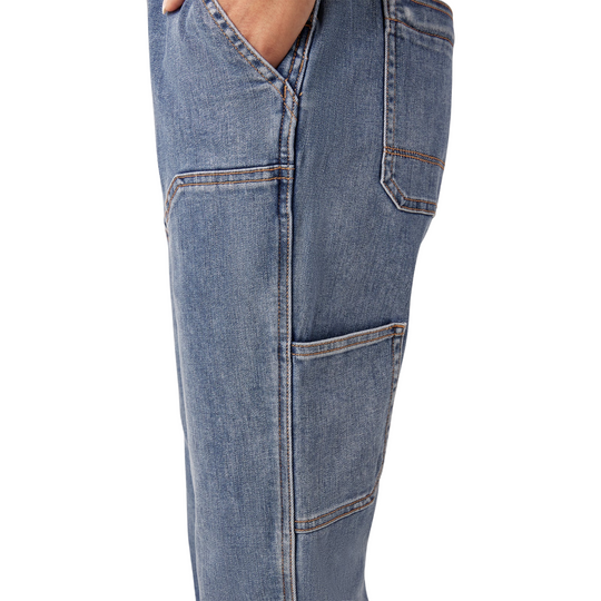 Dickies Women's Double Front Bib Overalls - Light Stonewash on a female model on a white background. Close up of leg pocket.