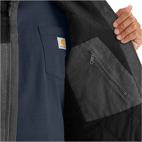 Carhartt Men's Montana Rugged Flex Duck Vest - Shadow/Black on a male model on a white background. Zoomed in on interior zipper pocket.