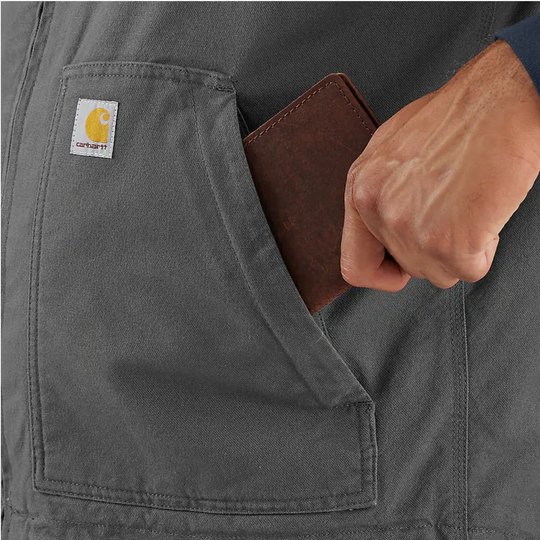 Carhartt Men's Montana Rugged Flex Duck Vest - Shadow/Black on a male model on a white background. Zoomed in on wallet going into pocket. 