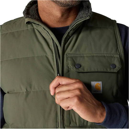 Carhartt Men's Montana Loose Fit Insulated Vest - Moss on a male model on a white background. Zoomed in on front zipper.