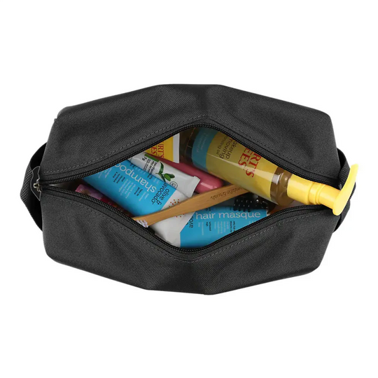 Carhartt Travel Kit - Black on a white background. With the zipper open and items in the bag.